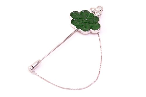 Lot 35 - A carved jade and diamond stick pin in the...