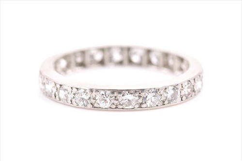 Lot 611 - A diamond eternity ring pave-set with...