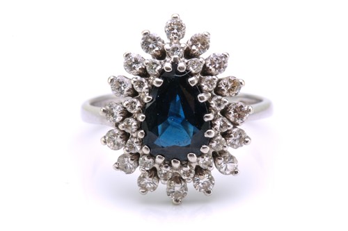 Lot 49 - A sapphire and diamond entourage ring,...