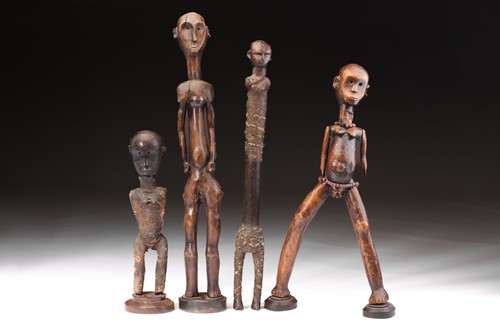 Lot 37 - A group of four Tanzanian standing figures,...