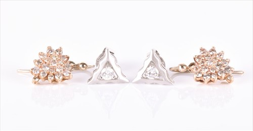 Lot 518 - A pair of white metal and diamond earrings the...