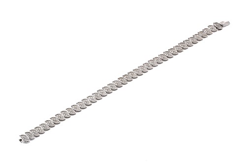 Lot 28 - A 9ct gold and diamond line bracelet, with...