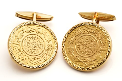 Lot 58 - A pair of coin cufflinks, each features a...