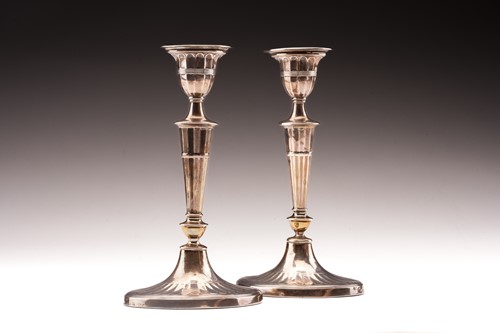 Lot 376 - A pair of George III style silver candlesticks;...