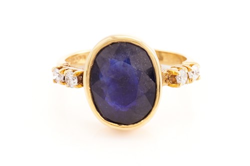 Lot 189 - A glass-filled sapphire and diamond ring in...