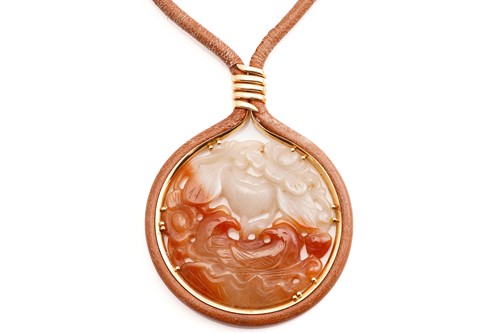Lot 148 - A Chinese carved jade ‘Magpie and Lotus'...