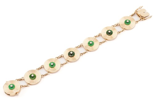 Lot 16 - A disc link bracelet set with jade and diamond,...