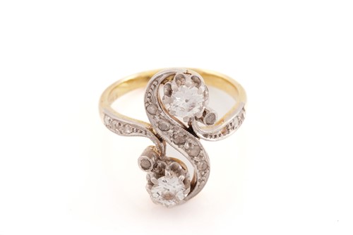 Lot 148 - A diamond Toi et Moi ring, of a twisted 'S'...