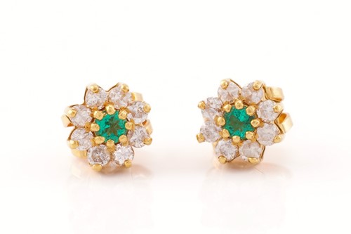 Lot 128 - A pair of emerald and diamond flowerhead...