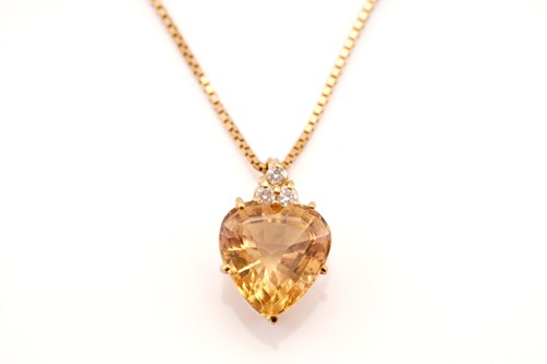 Lot 194 - A topaz and diamond pendant on chain,...