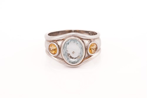 Lot 183 - A three-stone ring centrally set with an oval...