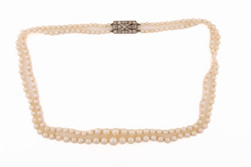 Lot 7 - A two-row graduated pearl necklace with...