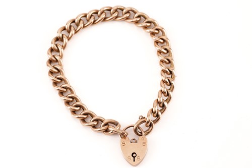 Lot 131 - A 9ct rose gold bracelet with a heart padlock,...