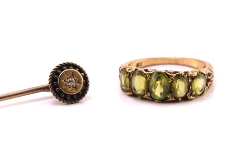 Lot 20 - A five-stone peridot half hoop ring and an...