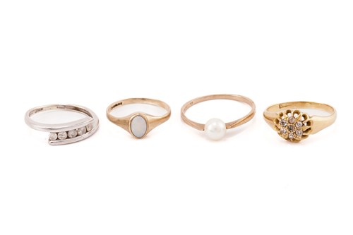 Lot 279 - Four gem-set rings; a pearl ring with a flat...
