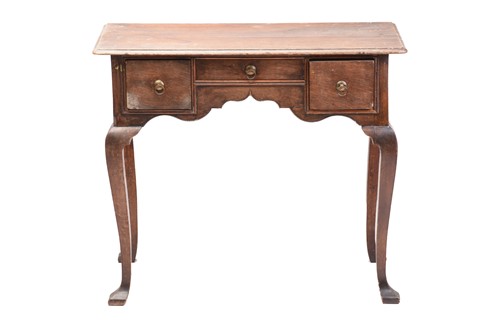 Lot 267 - An early 18th-century oak kneehole lowboy with...