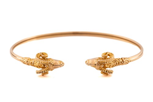Lot 222 - A Rams head flex torque bangle with two yellow...