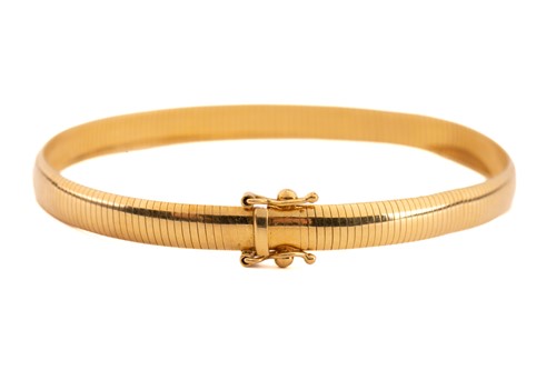 Lot 90 - A flat snake link bracelet, in yellow metal...