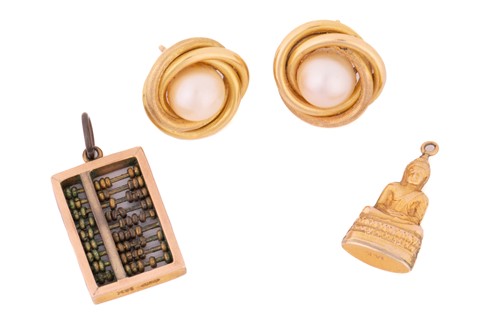 Lot 107 - A pair of pearl earrings along with two charms;...