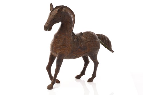 Lot 215 - An Asian patinated brass, possibly Indian...