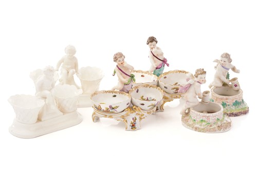 Lot 440 - A pair of Berlin salts, each with a putto...