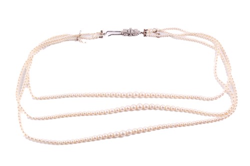 Lot 241 - A three-row pearl necklace, comprising three...