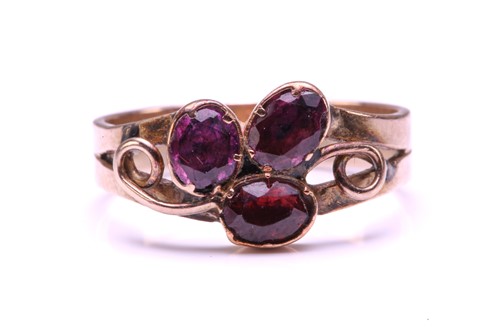 Lot 110 - A Ruby and Garnet floral ring, formed from two...