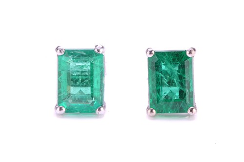 Lot 54 - A pair of emerald stud earrings, each...