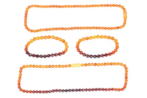 Lot 115 - A set of two amber bead bracelets and two...