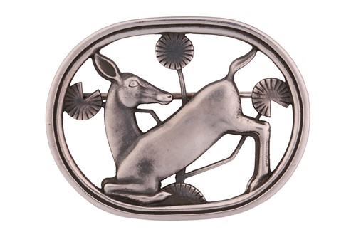 Lot 335 - Georg Jensen - a brooch depicting kneeling...