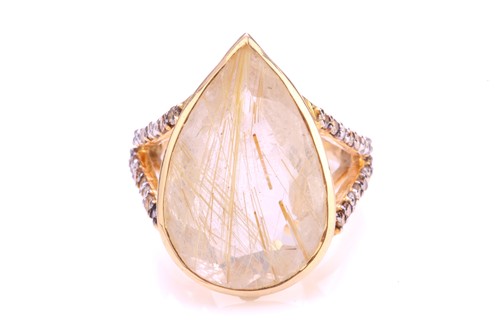 Lot 215 - A rutilated quartz dress ring, featuring...