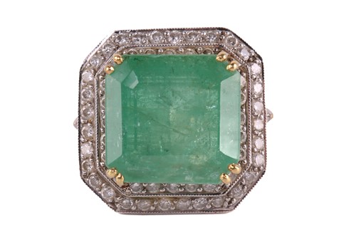 Lot 159 - An emerald and diamond cluster ring, featuring...