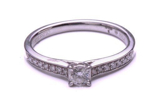 Lot 261 - A single stone diamond cross over ring; the...