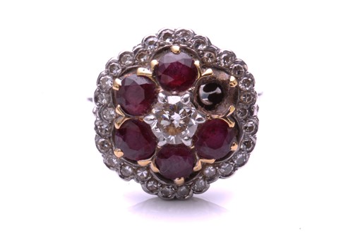 Lot 93 - A ruby and diamond cluster ring; the principal...