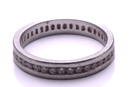 Lot 9 - A full hoop diamond eternity ring, the round...