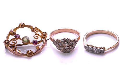 Lot 98 - An openwork diamond cluster ring; a five stone...