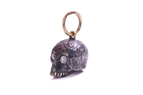 Lot 244 - A skull charm pendant with diamonds, a...