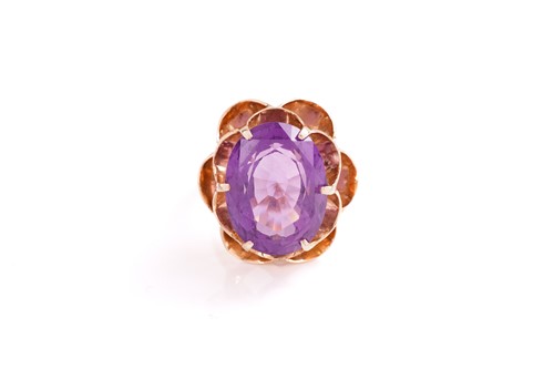 Lot 194 - An amethyst dress ring, featuring an...