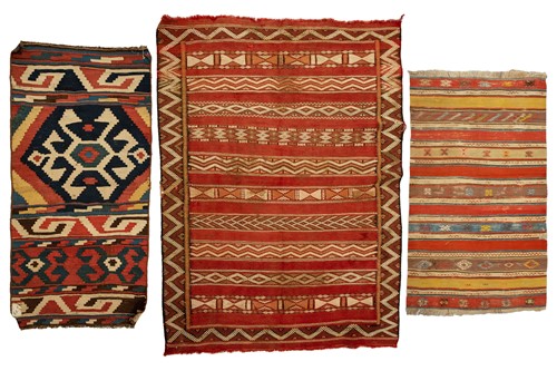Lot 318 - A North African red ground kelim with banded...