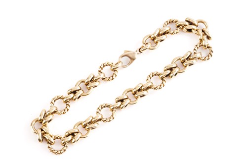 Lot 227 - A yellow metal fancy link bracelet of polished...