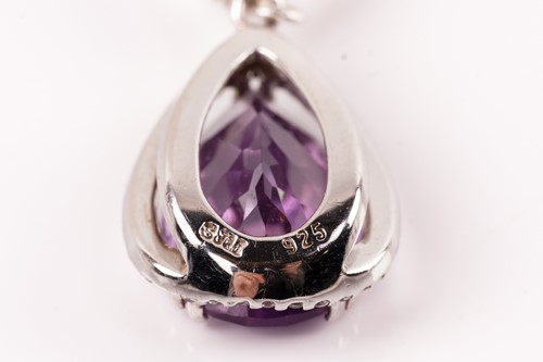 Lot 15 - A pair of amethyst and cubic zirconia pendant...
