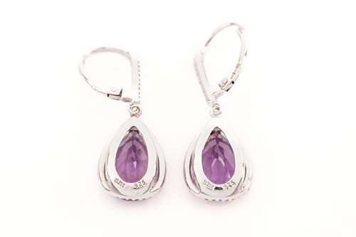 Lot 15 - A pair of amethyst and cubic zirconia pendant...
