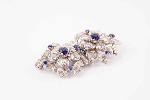 Lot 43 - A floral duette brooch set with sapphires and...