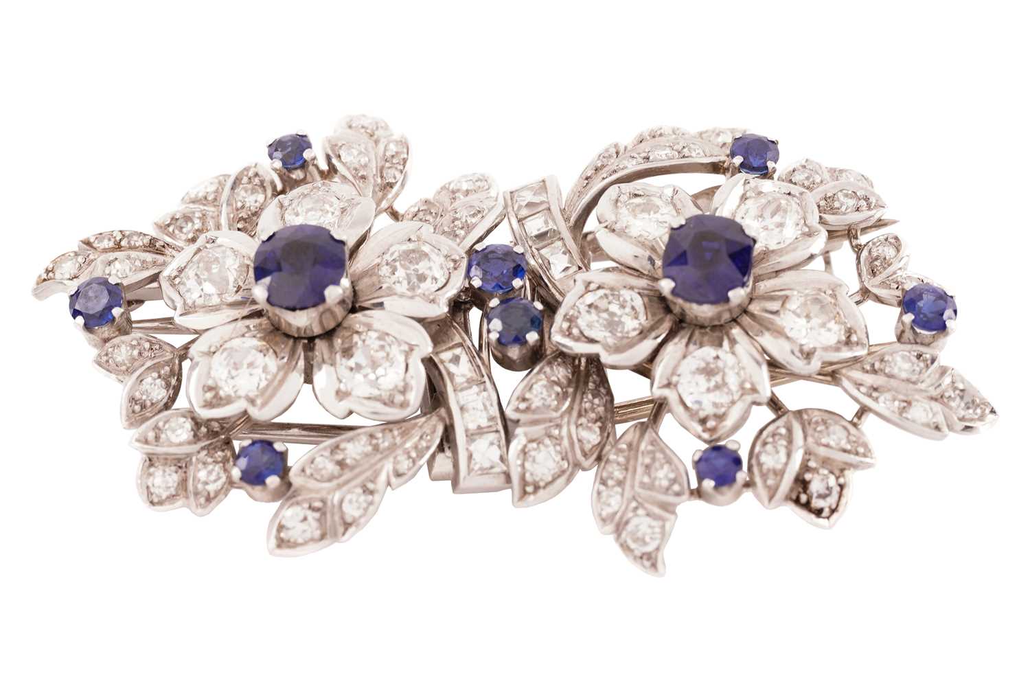 Lot 43 - A floral duette brooch set with sapphires and...