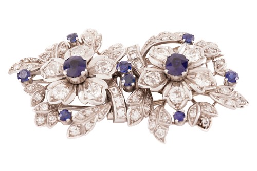 Lot 43 - A floral duette brooch set with sapphires and...