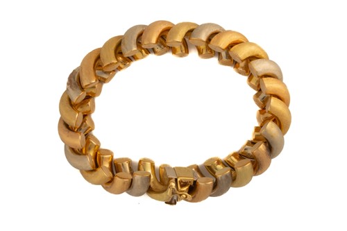 Lot 8 - A three-tone fancy link bracelet, of twisted...
