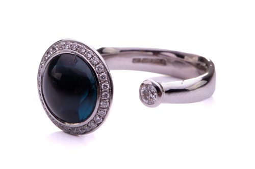 Lot 104 - A topaz and diamond open ring in 18ct white...