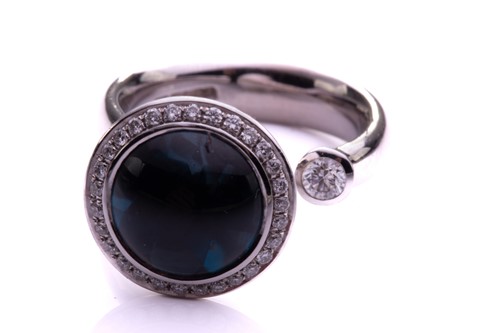 Lot 104 - A topaz and diamond open ring in 18ct white...