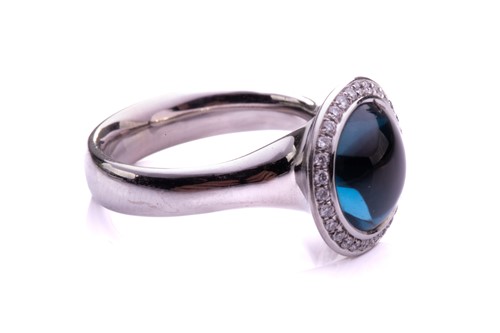 Lot 104 - A topaz and diamond open ring in 18ct white...