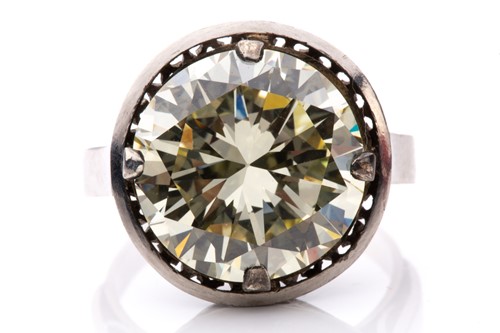 Lot 227 - A diamond solitaire ring, featuring a light...